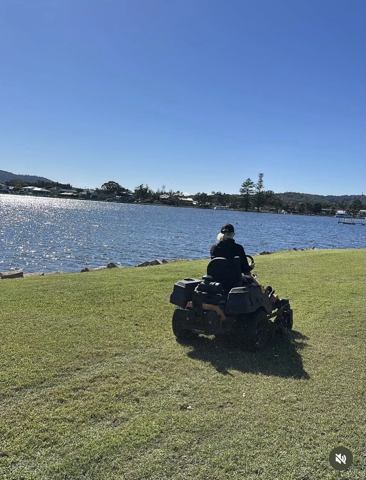 Ride-on mowing beside the waterfront