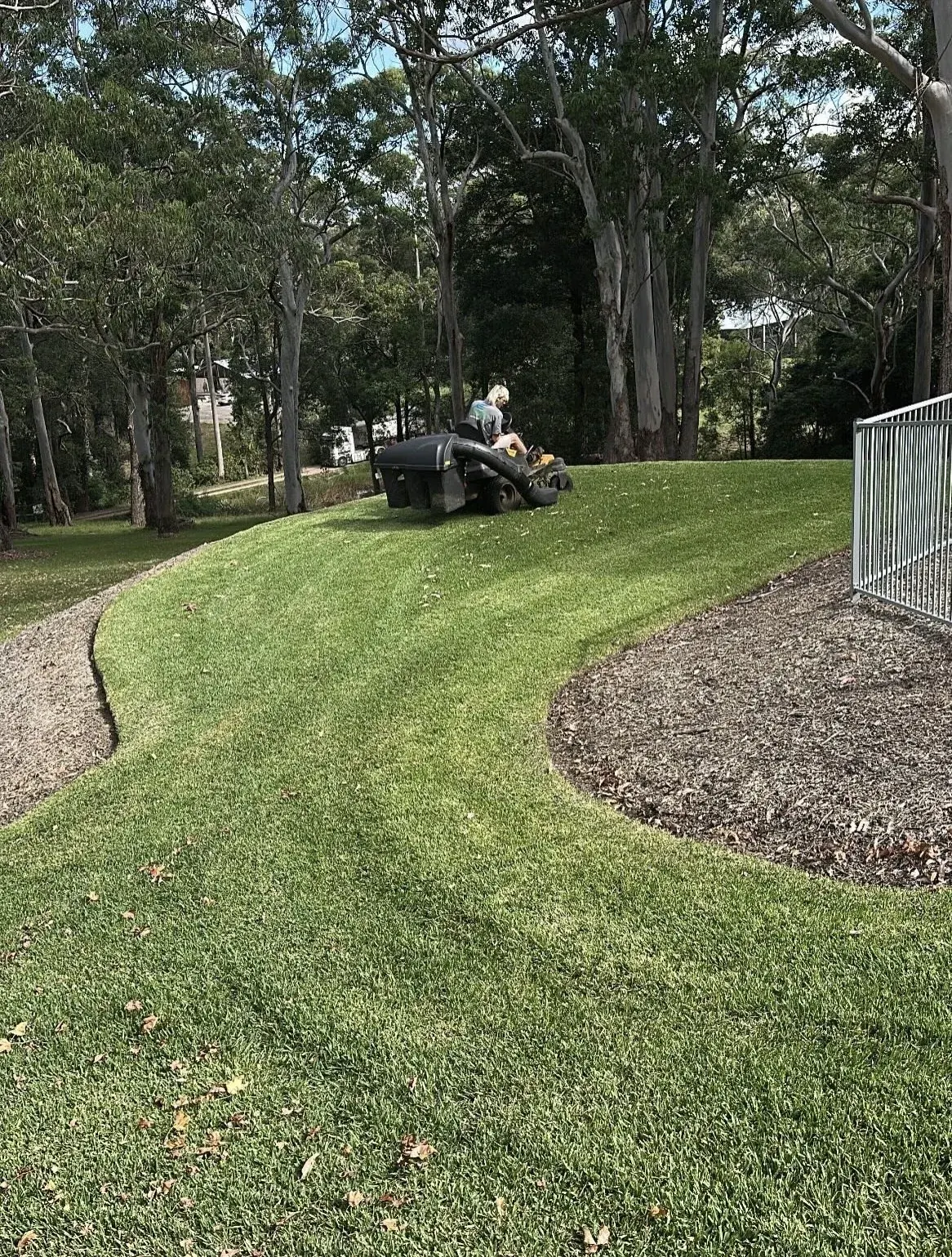 Ride-on mowing on a sloping lawn