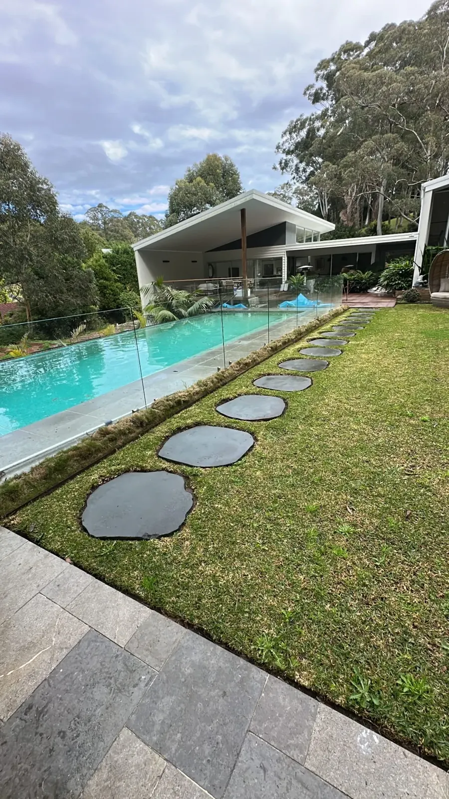Maintained lawn beside a swimming pool